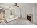 Living room featuring a fireplace, two sofas, and a ceiling fan at 10410 N Cave Creek Rd # 2060, Phoenix, AZ 85020