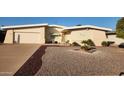 Single-level home with a landscaped front yard and attached garage at 10646 W Boswell Blvd, Sun City, AZ 85373