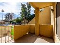 Private patio with access to a community pool and lush green space at 1126 W Elliot Rd # 1058, Chandler, AZ 85224