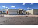 Front view of a tan house with a single car garage at 11616 N 30Th Ln, Phoenix, AZ 85029