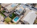 Aerial view of house with a backyard with pool and trampoline at 12378 W Roma Ave, Avondale, AZ 85392