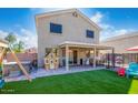 The backyard features a covered patio and artificial turf for low-maintenance outdoor living at 12378 W Roma Ave, Avondale, AZ 85392