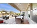 Spacious covered patio with seating area and dining table at 13360 W Red Hawk Dr, Peoria, AZ 85383