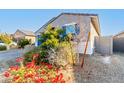 One story house with blue garage door and red flowers at 1523 S 223Rd Dr, Buckeye, AZ 85326