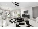 Open living room featuring modern furniture, neutral color palette, and an area rug at 1523 S 223Rd Dr, Buckeye, AZ 85326