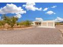 A single-story home featuring a gravel driveway and desert landscaping at 1628 E Magellan Dr, New River, AZ 85087