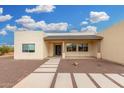 Tan single-story home with gravel yard and paver walkway at 1628 E Magellan Dr, New River, AZ 85087