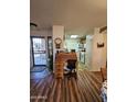 Entryway with a wooden desk and view into the kitchen at 16602 W Tasha Dr, Surprise, AZ 85388