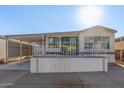 Single-wide manufactured home with carport and elevated deck at 17200 W Bell Rd # 517, Surprise, AZ 85374