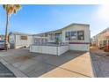 Single-wide manufactured home with carport and elevated deck at 17200 W Bell Rd # 517, Surprise, AZ 85374