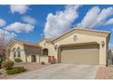 Tan house with arched windows and desert landscaping at 18114 W Desert Sage Dr, Goodyear, AZ 85338