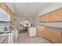 Bright kitchen with light wood cabinets, ample counter space, and a breakfast nook at 18840 N 83Rd Ln, Peoria, AZ 85382