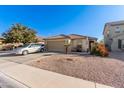 Single-story home with a two-car garage and desert landscaping at 18927 N Leland Rd, Maricopa, AZ 85138