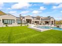 Luxury home featuring a large pool, spa, and expansive grassy backyard at 20646 N 112Th St, Scottsdale, AZ 85255