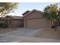 Single story home with two-car garage and desert landscaping at 2425 E Durango Dr, Casa Grande, AZ 85194