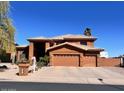 Inviting two-story home with tile roof, large garage, desert landscaping, and concrete driveway at 2837 N Whiting Cir, Mesa, AZ 85213