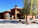 Inviting two-story home with tile roof, large garage, desert landscaping, and mature trees at 2837 N Whiting Cir, Mesa, AZ 85213