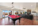 Game room features a pool table, comfortable seating, and fireplace at 2837 N Whiting Cir, Mesa, AZ 85213