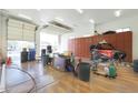 Large garage with ample space for cars, storage, and workshop at 2837 N Whiting Cir, Mesa, AZ 85213