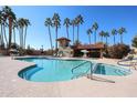 Inviting community pool with surrounding lounge chairs and palm trees at 3013 W Phelps Rd, Phoenix, AZ 85053