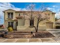 Two-story house with tile roof, stone accents, and a three-car garage at 30773 N 129Th Ave, Peoria, AZ 85383