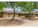 Ranch style home with landscaped yard and two-car garage at 3136 W Sunnyside Ave, Phoenix, AZ 85029