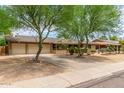 Ranch style home with landscaped yard and two-car garage at 3136 W Sunnyside Ave, Phoenix, AZ 85029