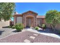 Charming ranch-style home with stone accents and well-manicured landscaping at 3818 N Kalispell Ct, Casa Grande, AZ 85122