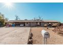 Ranch-style home with a long driveway and carport at 4035 W Country Gables Dr, Phoenix, AZ 85053