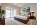 Bright bedroom with sliding glass doors, plush carpeting and modern furnishings at 4116 E Sunnyside Dr, Phoenix, AZ 85028