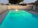 Inviting swimming pool with gray coping and lighting at 4220 W State Ave, Phoenix, AZ 85051