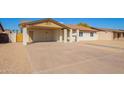 Single-story home featuring a covered carport and desert landscaping at 4220 W State Ave, Phoenix, AZ 85051