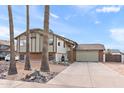 Two-story house with a spacious driveway and mature palm trees at 4947 E Adobe St, Mesa, AZ 85205