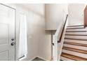 Clean and bright entryway with a wooden staircase leading upstairs at 4947 E Adobe St, Mesa, AZ 85205