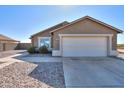 House exterior featuring a large garage and a rock pathway at 5175 W Warren Dr, Casa Grande, AZ 85194