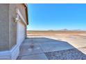 Side view of the house with a view of the open field and mountains at 5175 W Warren Dr, Casa Grande, AZ 85194