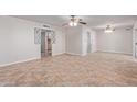 Bright and spacious living room with tile flooring and ceiling fans at 5804 E Dallas St, Mesa, AZ 85205