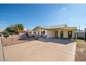 Front view of a ranch house with a carport at 6815 W Reade Ave, Glendale, AZ 85303