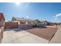 House exterior with driveway and a wood gate at 6815 W Reade Ave, Glendale, AZ 85303