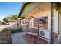 Front porch with a metal bench and AC unit at 6815 W Reade Ave, Glendale, AZ 85303