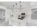 Modern kitchen with white cabinets, quartz countertops and island at 7235 E Norwood St, Mesa, AZ 85207