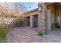 Covered entrance and courtyard with stone pillars, lighting, and desert landscaping at 7456 S Brighton --, Queen Creek, AZ 85142