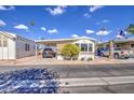 Front view of a manufactured home with a carport and landscaping at 7750 E Broadway Rd # 684, Mesa, AZ 85208