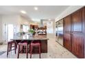 Spacious kitchen features stainless steel appliances, large island with counter seating and tile floors at 9015 E Hackamore Dr, Scottsdale, AZ 85255