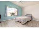 Bright bedroom with large window and light-colored flooring at 9016 W Harmony Ln, Peoria, AZ 85382