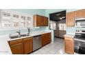 Kitchen with light wood cabinets, stainless steel appliances, and tiled floors at 9016 W Harmony Ln, Peoria, AZ 85382