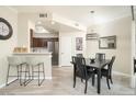 Elegant dining room with a table for four and kitchen bar access at 9151 W Greenway Rd # 276, Peoria, AZ 85381