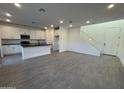 Modern kitchen with white cabinets, black countertops, and tile floors at 9346 E Sequence Ave, Mesa, AZ 85212