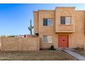 Tan two-story townhome with red door and small front yard at 948 S Alma School Rd # 29, Mesa, AZ 85210