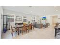Open concept dining area with modern table and adjacent living room at 12530 W Levi Dr, Avondale, AZ 85323